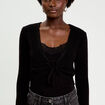 Pull cropped avec noeud noir femme