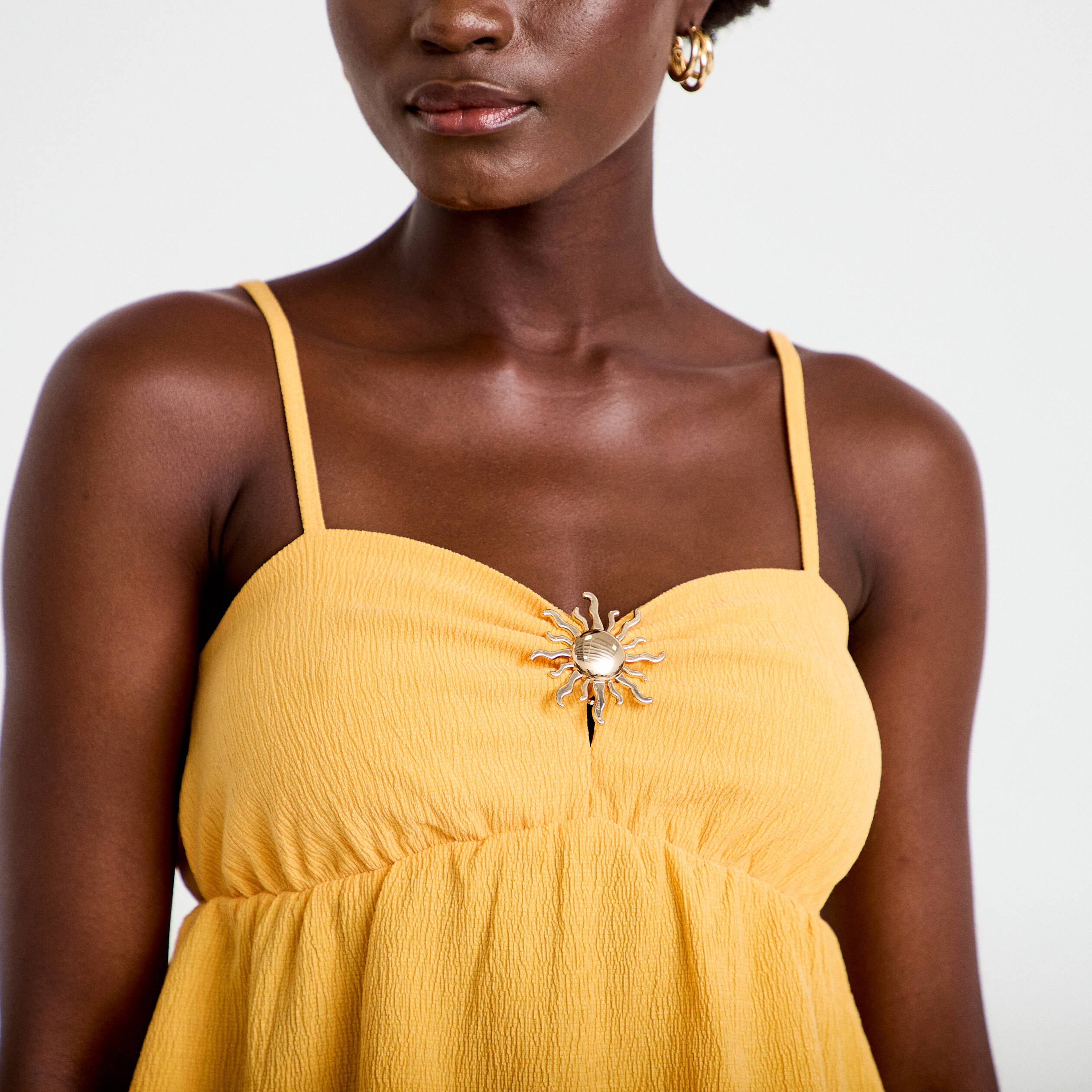 D&eacute;bardeur d&eacute;tail bijou orange clair femme
